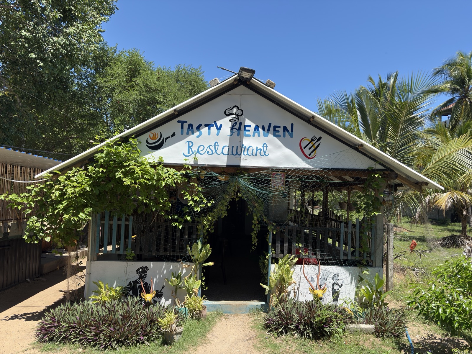 Restaurant front surrounded by leafy vines