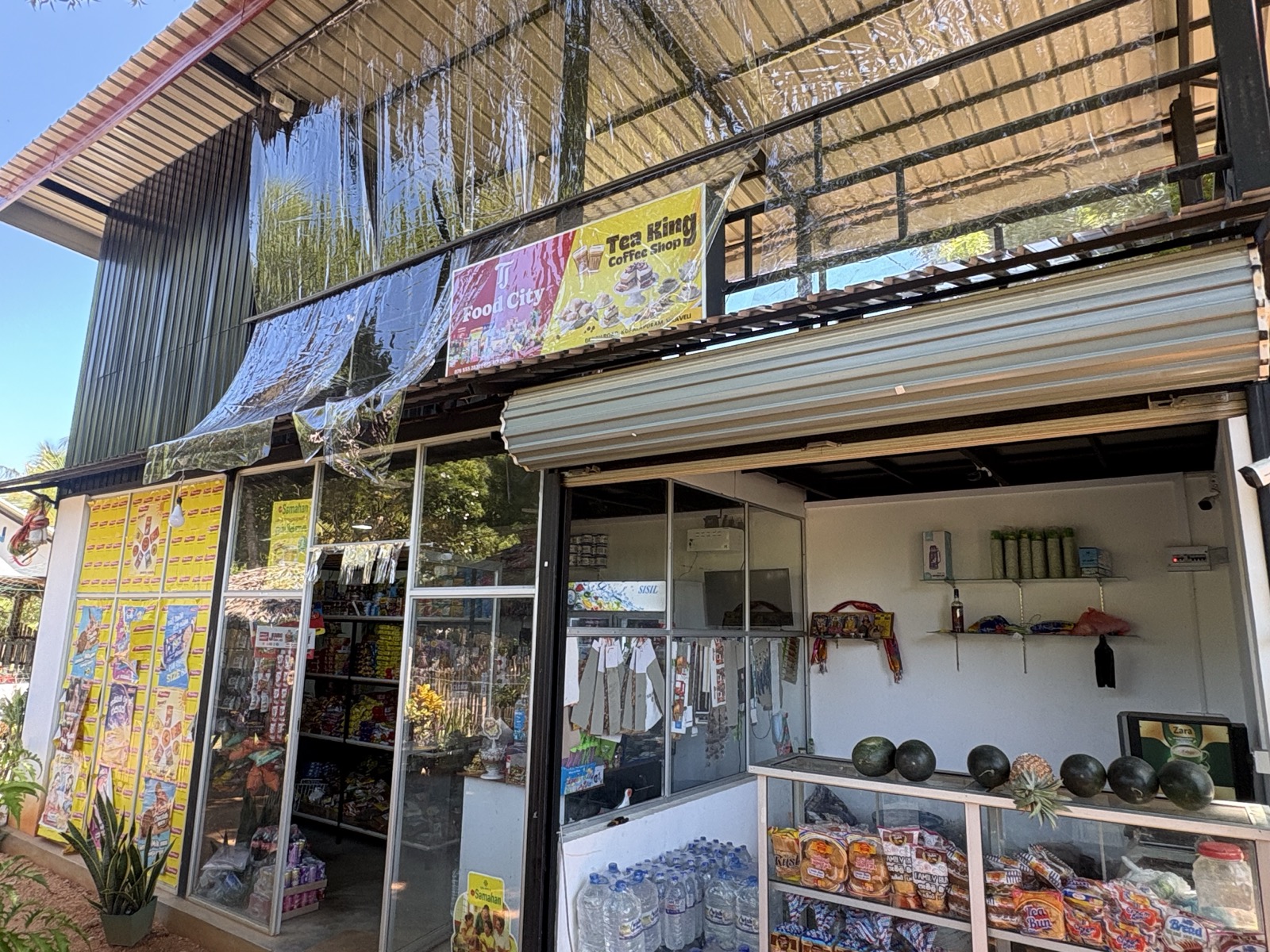 Food City storefront with watermelons and pineapples